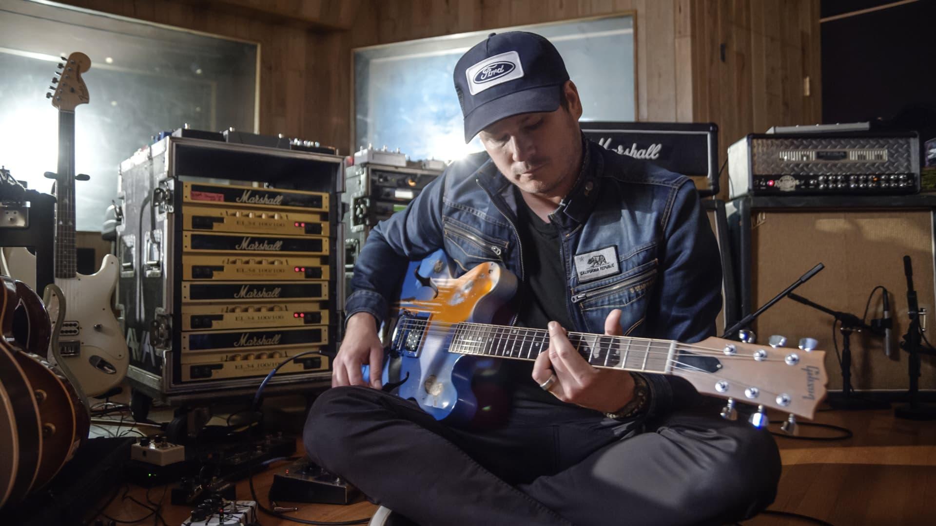 Ernie Ball: The Pursuit of Tone - Tom DeLonge backdrop