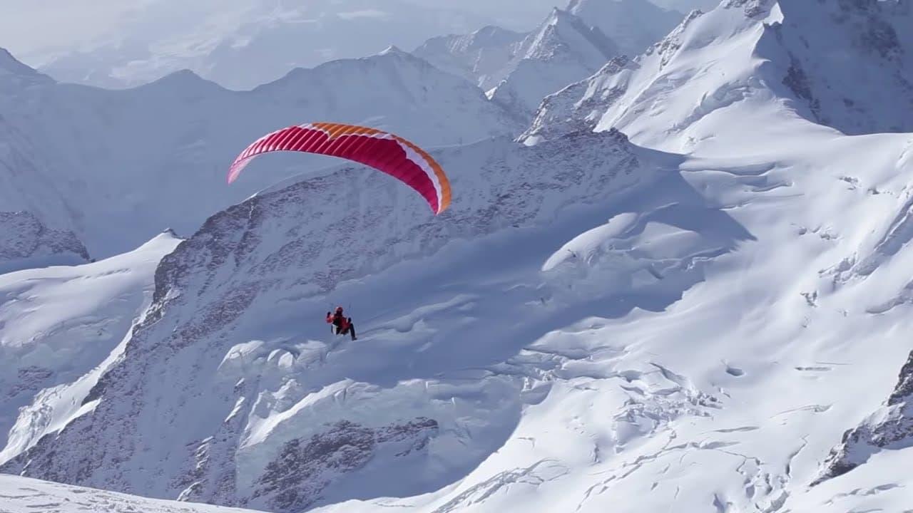 Ueli Steck - Paraglides Between Mountains In The Swiss Alps backdrop